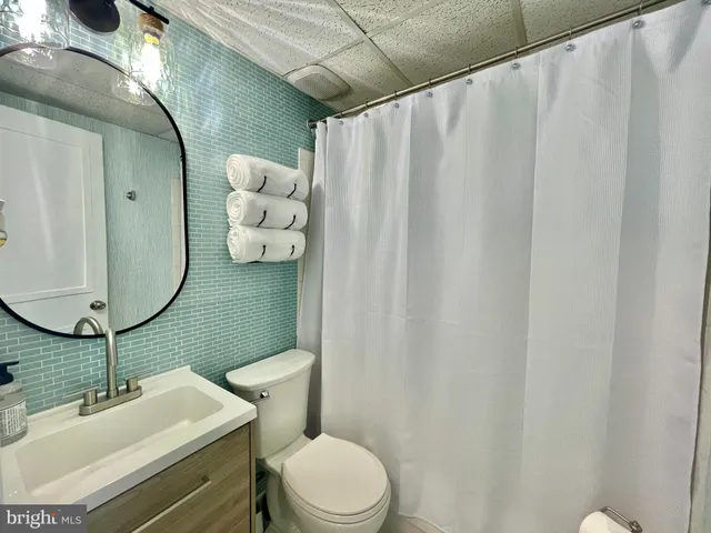 a kitchen with stainless steel appliances granite countertop a sink dishwasher a stove and a refrigerator with wooden cabinets