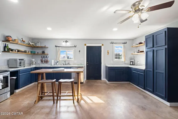 a view of house with large space and a car parked