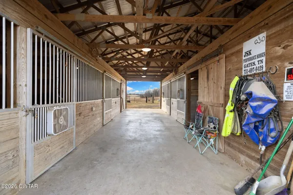 a room with stainless steel appliances kitchen island granite countertop a sink and cabinets