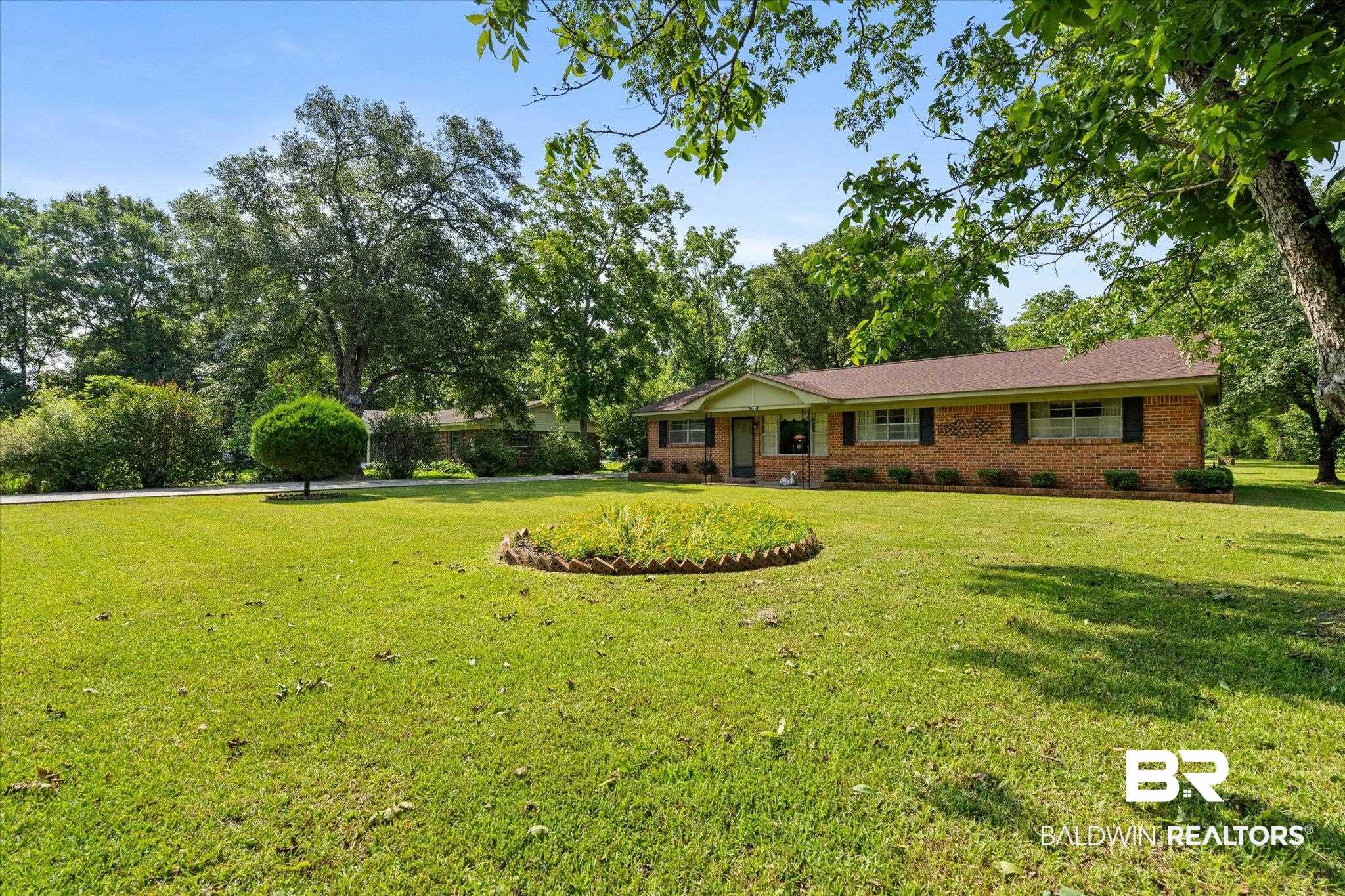 423 First Avenue Saraland, AL 36571 - Photo 20 of 20 Ranch-style home with a front lawn and brick siding