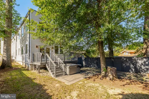 a view of a house with backyard porch and sitting area