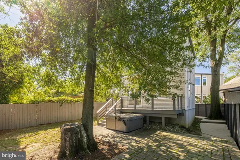 a backyard of a house with barbeque oven and outdoor seating