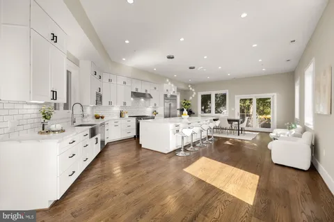 a living room with kitchen island furniture and a large window