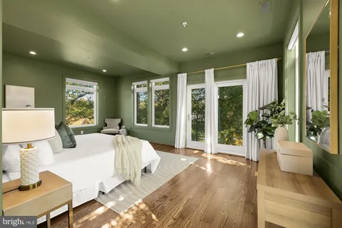 a large bedroom with a large bed and a large window