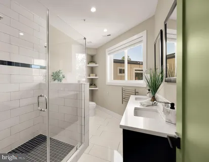 a bathroom with a sink shower and a mirror