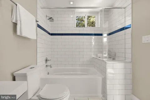 a bathroom with a toilet and a bathtub