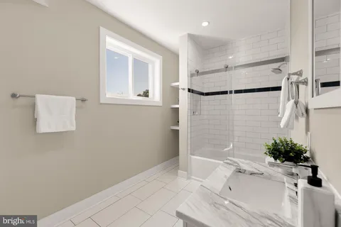 a bathroom with a bathtub and shower