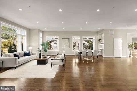 a living room with lots of furniture and view of kitchen