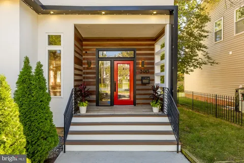 a front view of a house with a porch and furniture