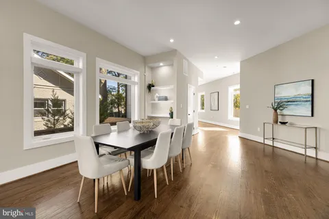 a view of a a dining room with furniture window and wooden floor