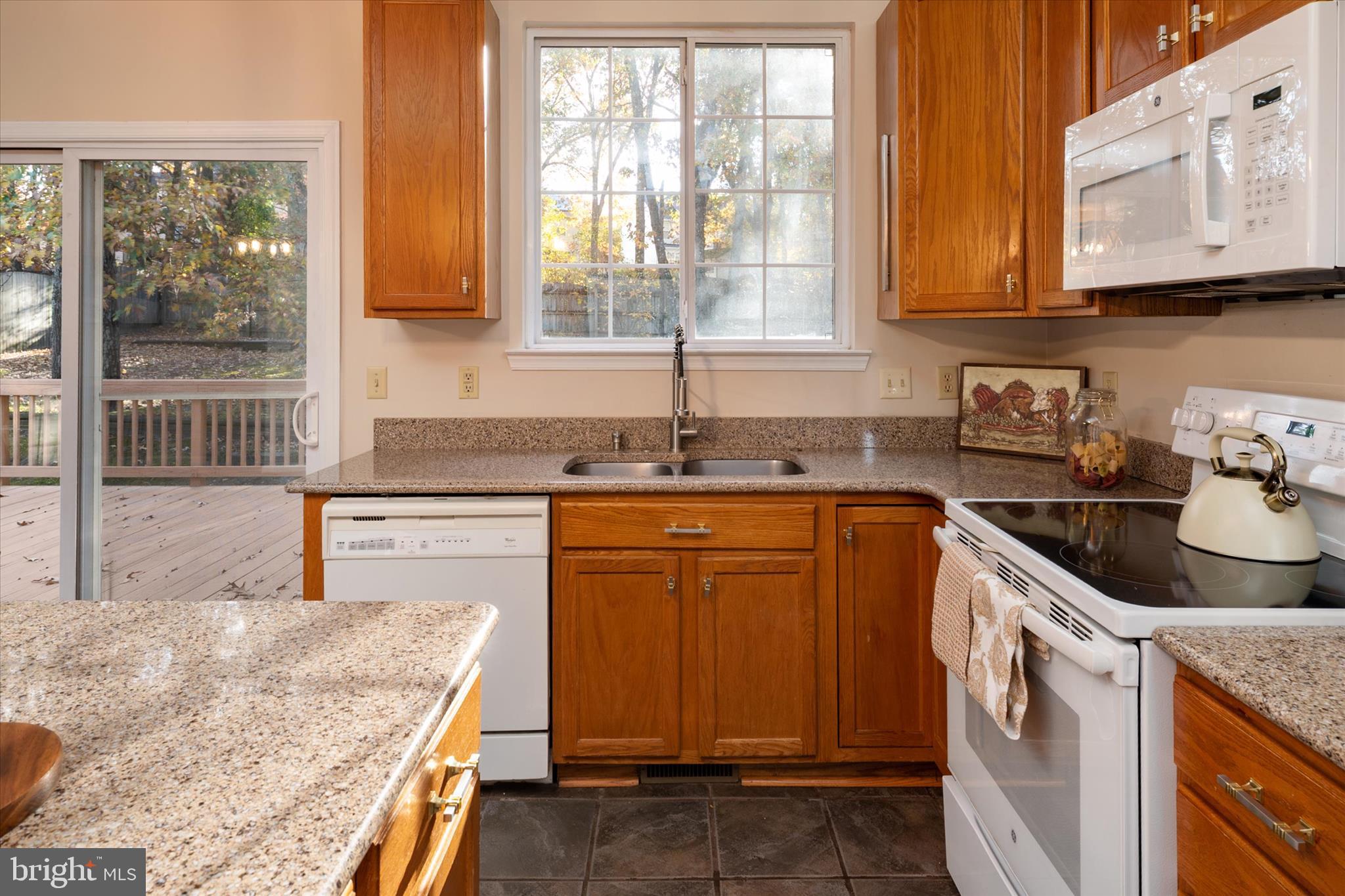 1409 Sweet Cherry Court Severn, MD 21144 - Photo 13 of 56 a kitchen with stainless steel appliances granite countertop a sink stove and cabinets