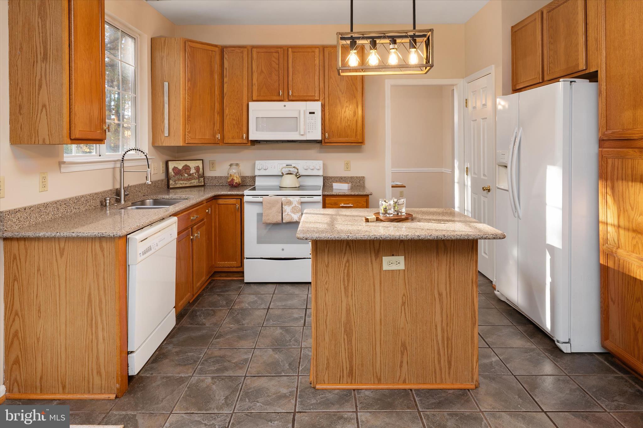 1409 Sweet Cherry Court Severn, MD 21144 - Photo 14 of 56 a kitchen with stainless steel appliances granite countertop a sink stove and refrigerator