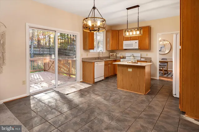 a view of a house with a wooden fence and a large window