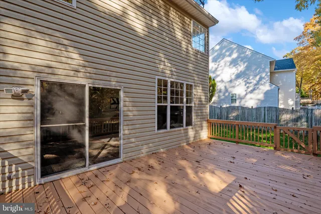 a view of balcony with wooden floor and fence