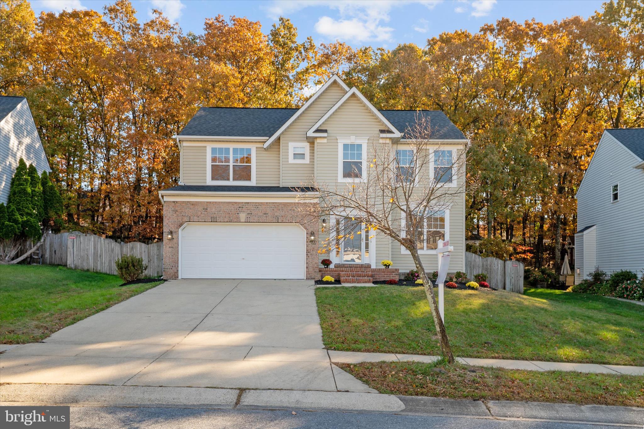 1409 Sweet Cherry Court Severn, MD 21144 - Photo 2 of 56 a front view of a house with a yard and trees