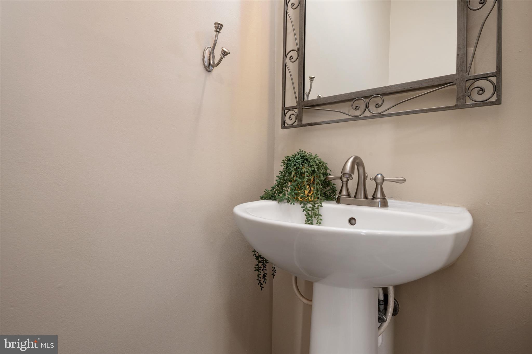 1409 Sweet Cherry Court Severn, MD 21144 - Photo 21 of 56 a bathroom with a sink and mirror