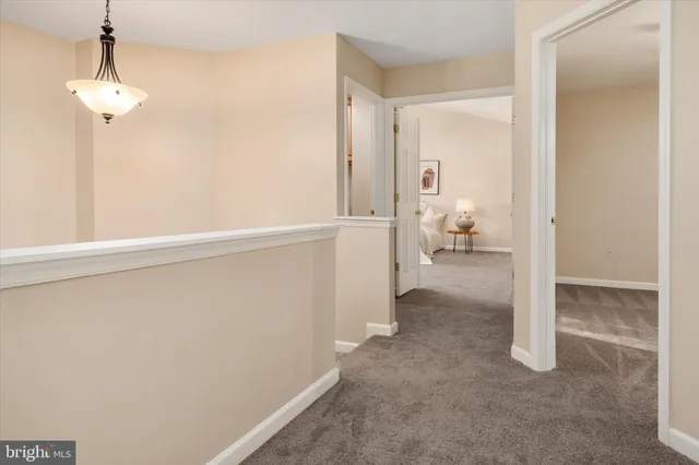 a spacious bedroom with a bed and a large window