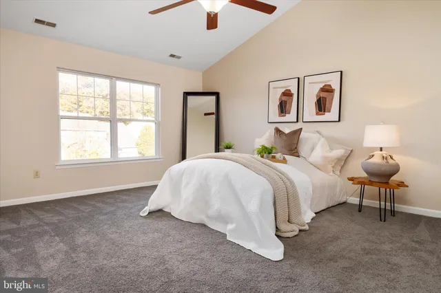 a bedroom with a bed and a large window