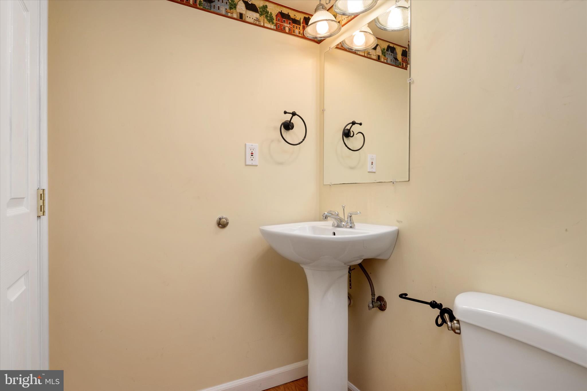 1409 Sweet Cherry Court Severn, MD 21144 - Photo 44 of 56 a bathroom with a sink and mirror with toilet
