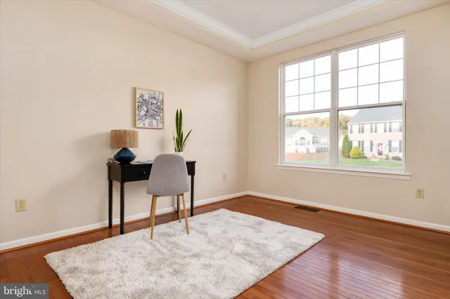 a view of a room with wooden floor and windows