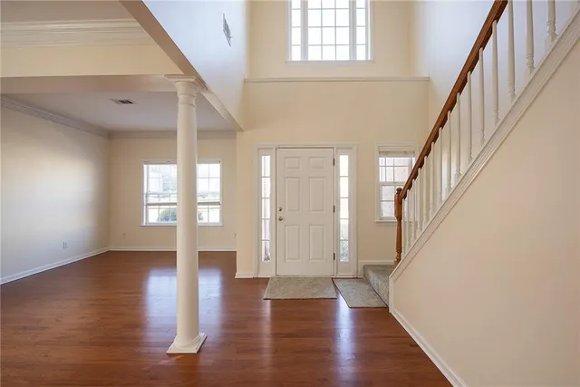 a view of an entryway with wooden floor and windows