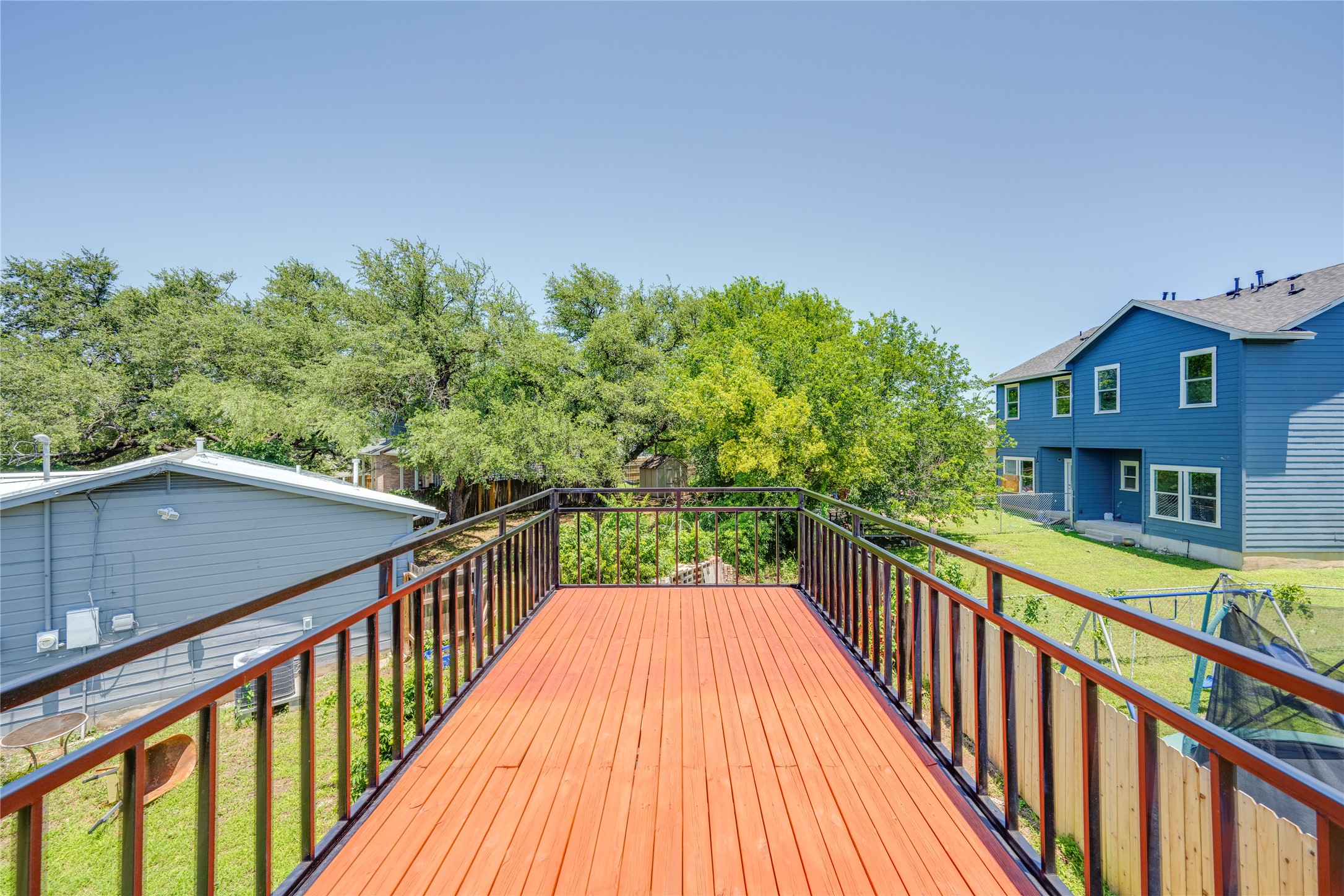 1707 Overhill Drive Austin, TX 78721 - Photo 22 of 36 An inviting elevated wood deck provides a serene outdoor living space.
