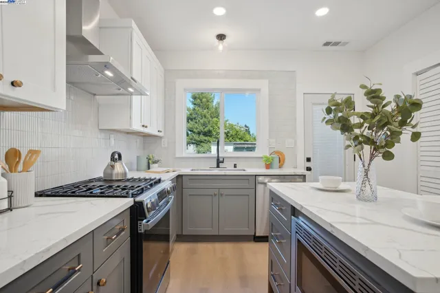 a kitchen with a sink stove and cabinets
