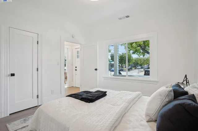 a bedroom with a bed and a window