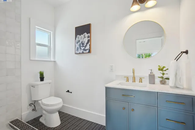 a bathroom with a toilet a sink and a mirror