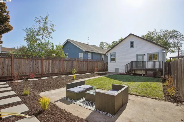 a view of a house with backyard and sitting area