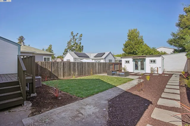 a view of a house with backyard and sitting area