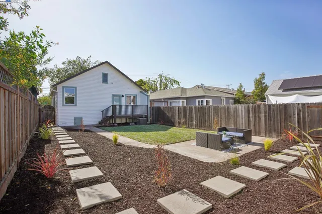 a view of a backyard with a patio and outdoor seating