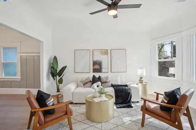 a living room with furniture and a potted plant