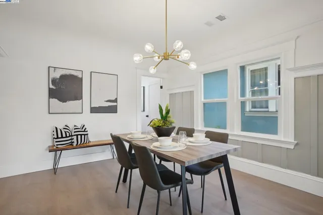 a view of a dining room with furniture and chandelier