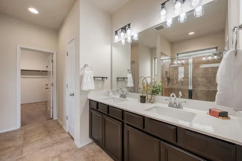 a bathroom with a shower a sink and a mirror