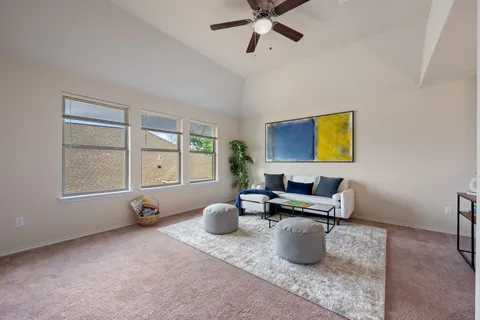 a view of an empty room and a ceiling fan