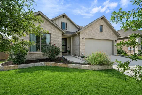 a view of a hallway with wooden floor and windows
