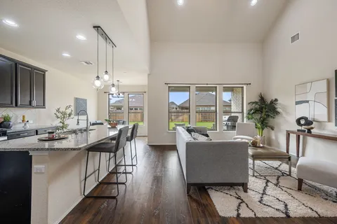 a living room with kitchen island furniture and a large window