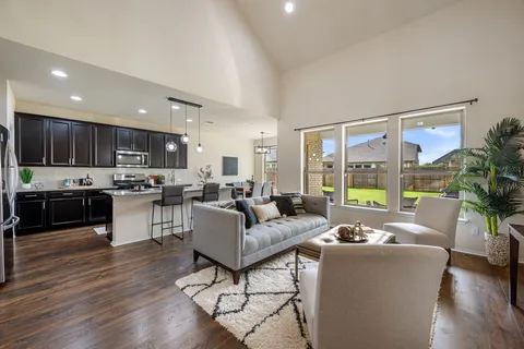 a living room with furniture and wooden floor