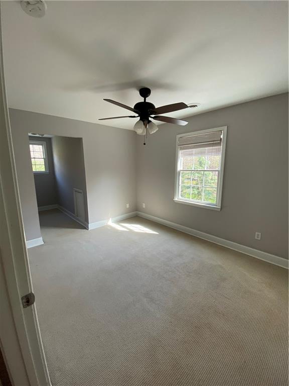 6175 Jett Road Dawsonville, GA 30534 - Photo 22 of 60 a view of a livingroom with a ceiling fan and window