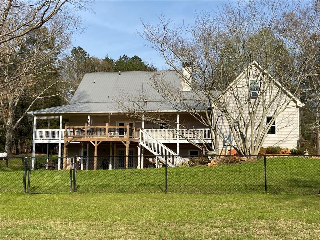 6175 Jett Road Dawsonville, GA 30534 - Photo 56 of 60 a view of a house with backyard and a tree