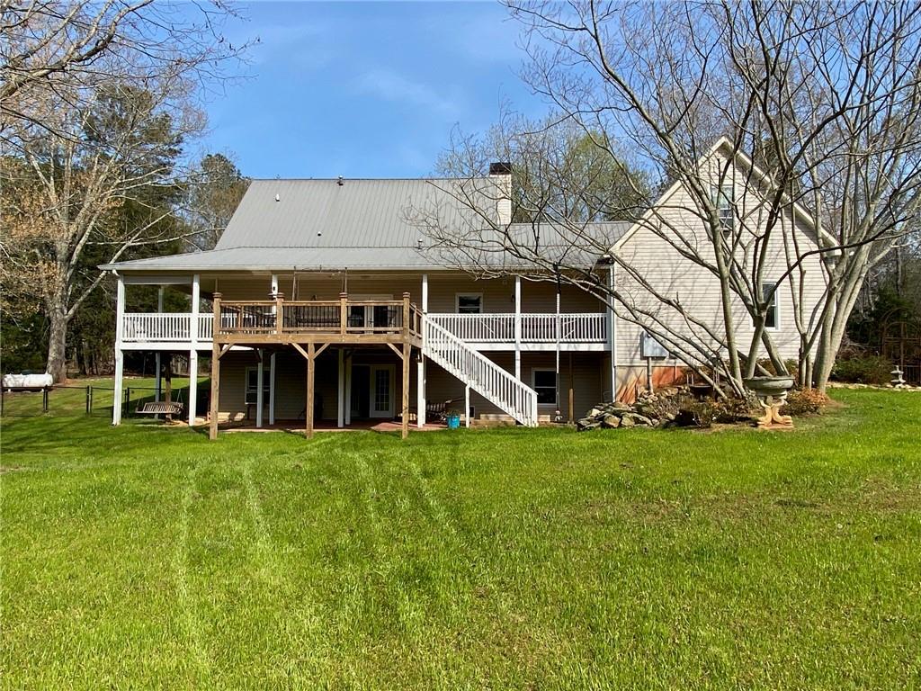 6175 Jett Road Dawsonville, GA 30534 - Photo 57 of 60 a view of a house with yard and large trees