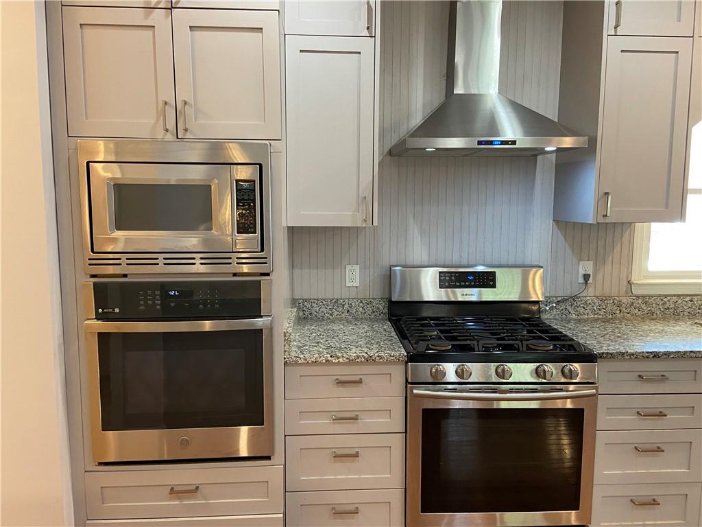6175 Jett Road Dawsonville, GA 30534 - Photo 10 of 60 a stove top oven sitting inside of a kitchen
