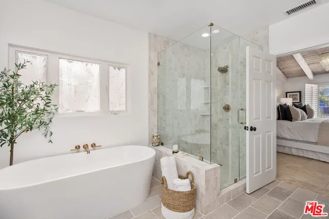 a bathroom with a bathtub and a shower