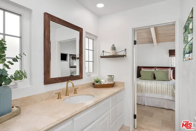 a en suite bathroom with a double vanity sink and a mirror