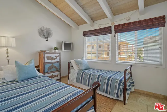 a bedroom with furniture and a window