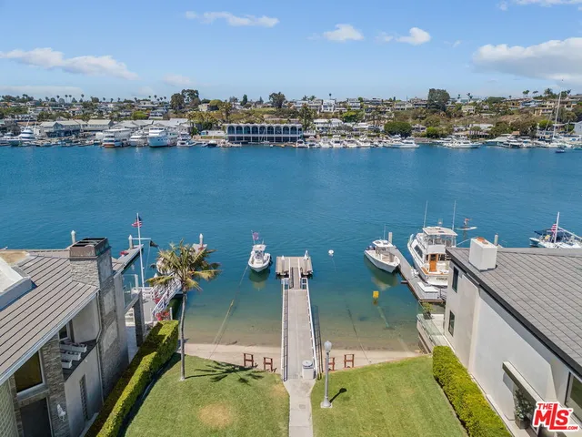 an aerial view of a house with outdoor seating