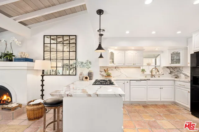 a kitchen with granite countertop a sink stove and cabinets