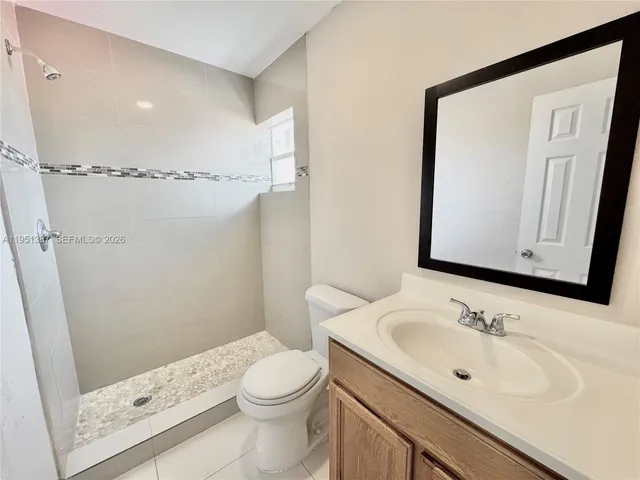 a view of a house with a wooden fence