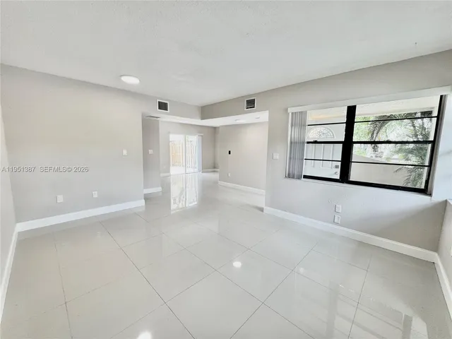 an empty room with windows and closet